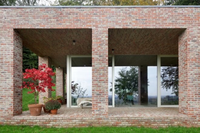brick home with full-height windows