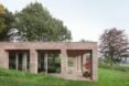 side of brick home surrounded by greenery