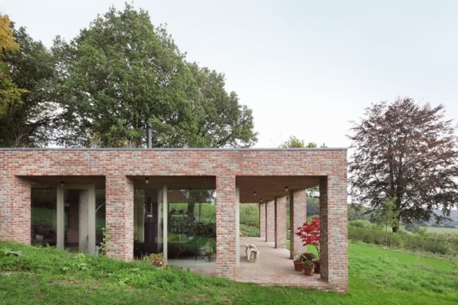 side of brick home surrounded by greenery