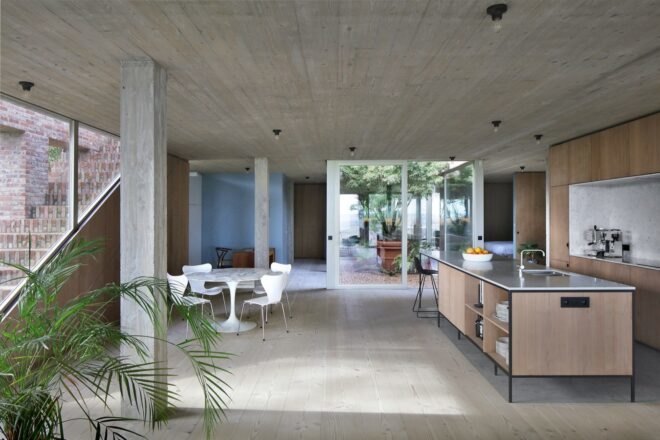 light wood kitchen and small white dining table and chairs