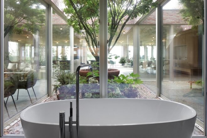 large white bathtub near glass walls