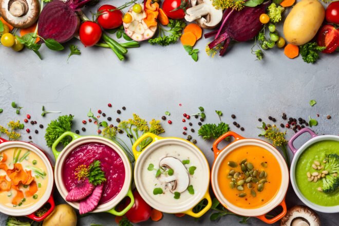 colorful vegan soups on gray background