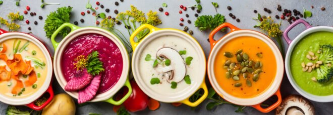 colorful vegan soups on gray background