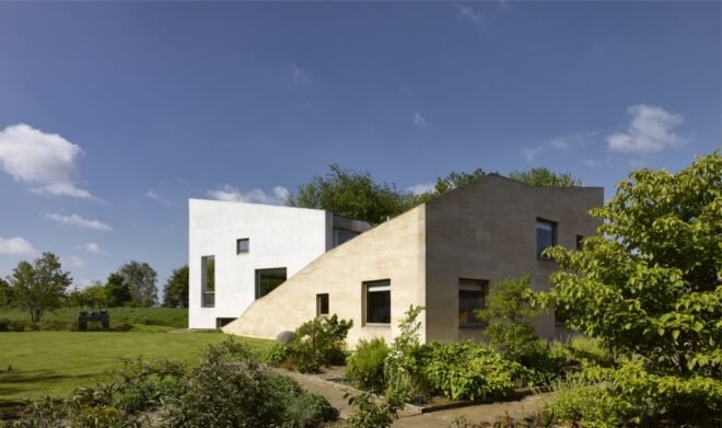 side angle of the Stonecrop building, showing a green, plant-filled area to the side
