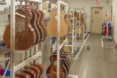 racks of guitars hanging up in a storage room