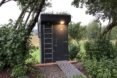ladder leading to rooftop garden on a black timber outhouse