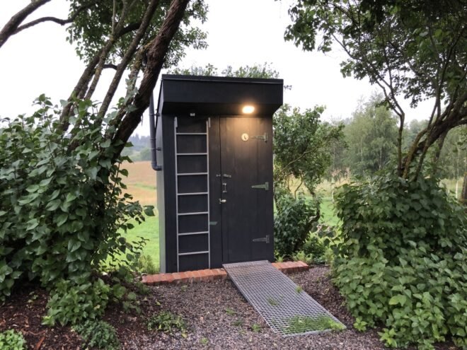 ladder leading to rooftop garden on a black timber outhouse