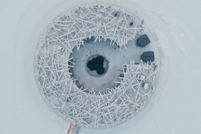 aerial shot of nestlike building with pool in the middle