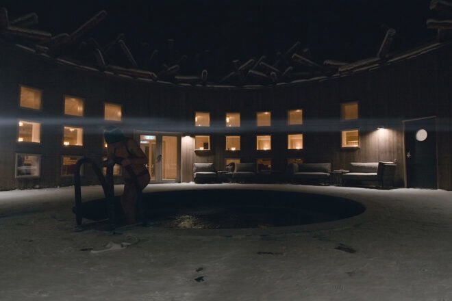 woman getting out of pool at night