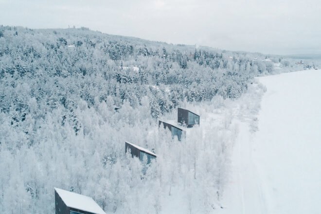 several cabins in a snow-covered forest