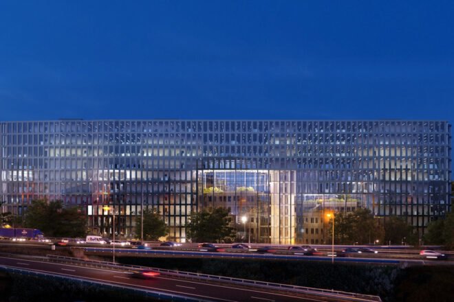 exterior of a building with a glass/windowed facade at night