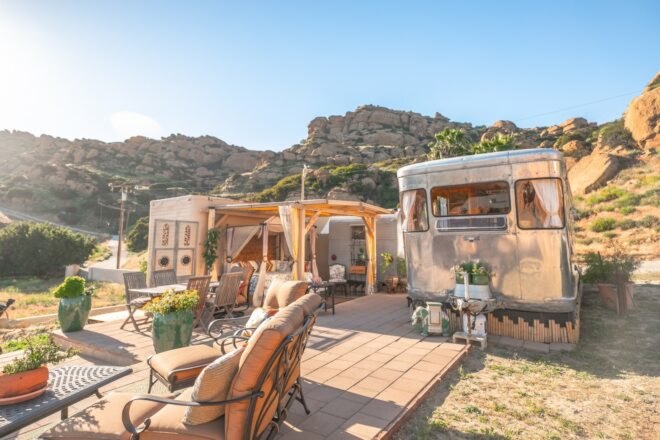 outdoor area with multiple silver travel trailers and an outdoor deck