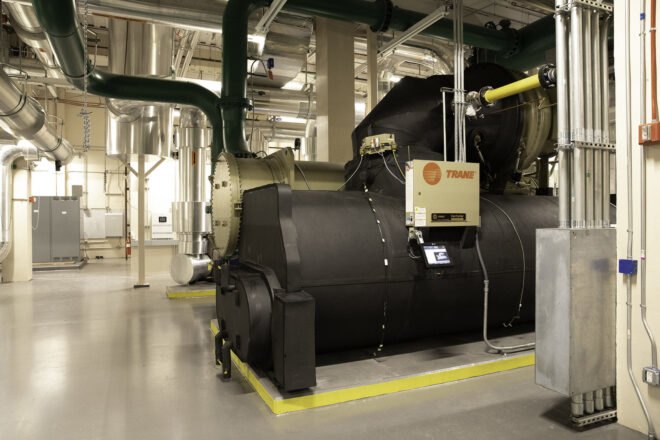 interior of a factory-like area, featuring the front of a black machine