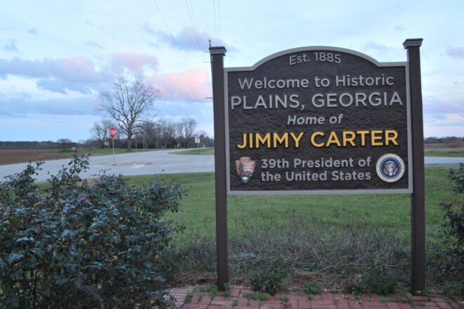 brown sign that reads, "Welcome to Plains, Georgia, home of Jimmy Carter, 39th President of the United States"