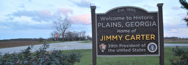 brown sign that reads, "Welcome to Plains, Georgia, home of Jimmy Carter, 39th President of the United States"