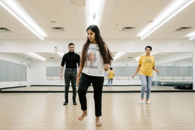 students practicing choreography in a dance studio