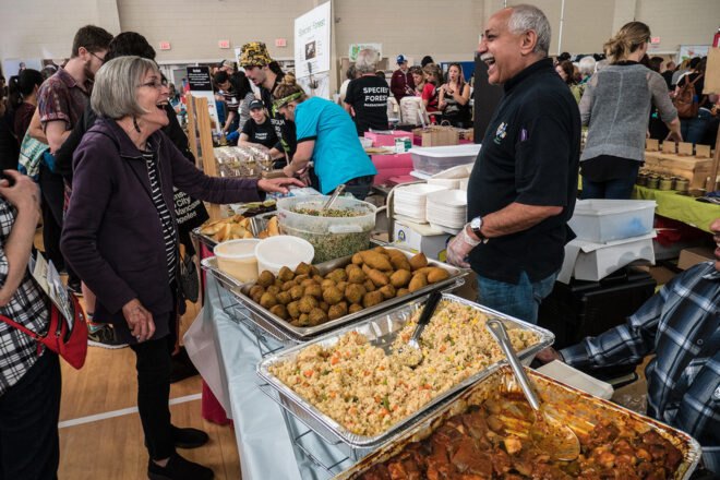 people talking while serving buffet-style vegan food