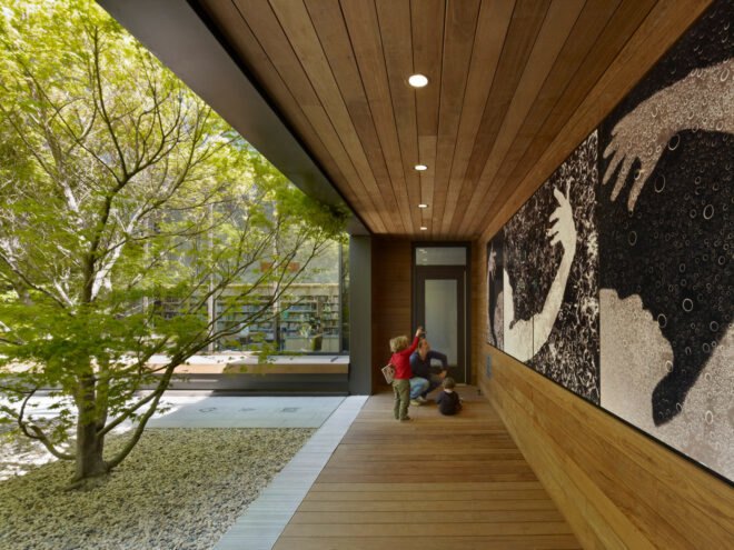 parent and child looking at art outside a library