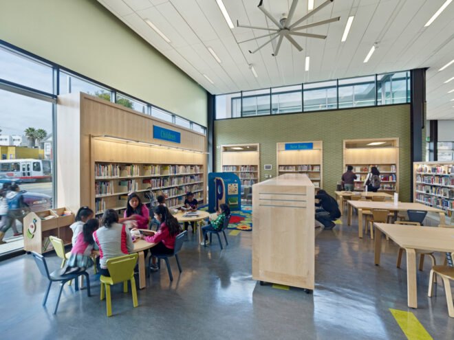 groups of people at tables inside a library