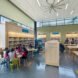 groups of people at tables inside a library