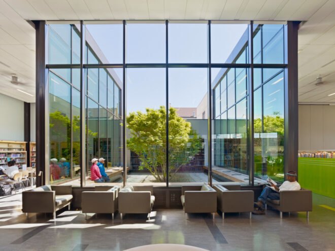 beige sofas near wall of glass