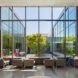 beige sofas near wall of glass