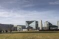 mirrored cube building as part of a city skyline