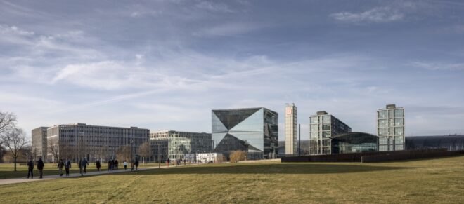mirrored cube building as part of a city skyline