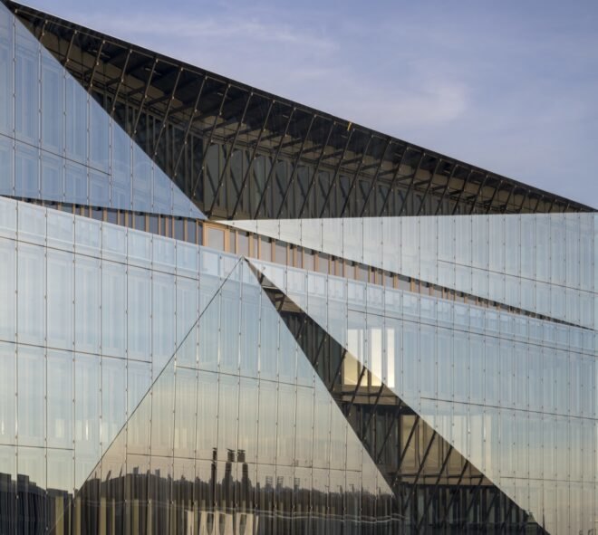 close-up of all-glass building with angular roof
