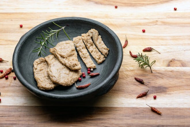 fake meat that looks like chicken in a slate gray bowl
