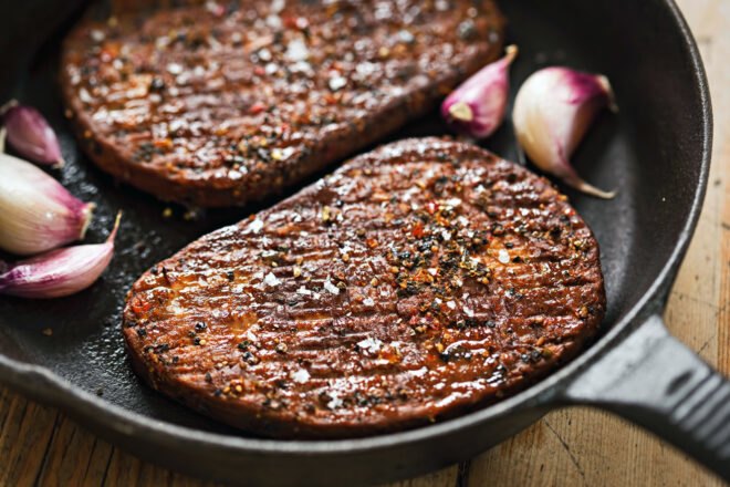 steak substitute and shallots in a cast iron skillet