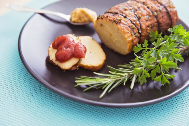 fake meat loaf on a gray plate with rosemary