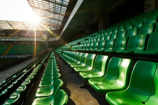 green plastic seats in a sports stadium