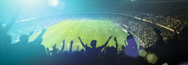 fans cheering in a soccer stadium
