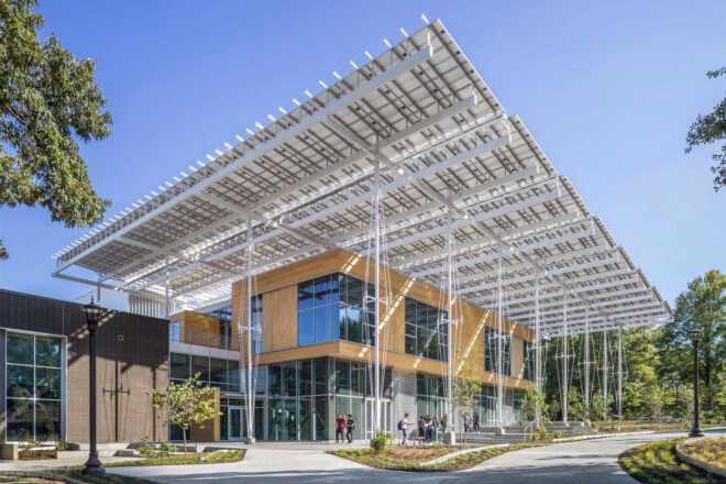 light wood and glass building with large roof