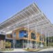light wood and glass building with large roof