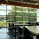 classroom with wall of glass and several wood tables