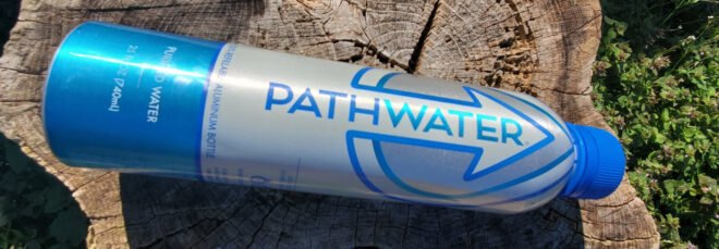 aluminum water bottle on a tree stump