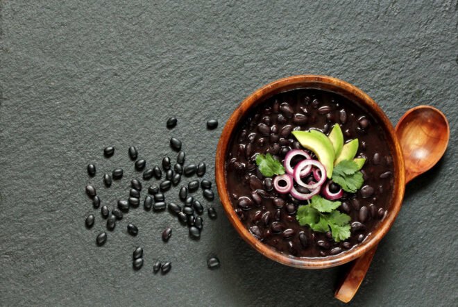 black beans beside a bowl of black bean soup