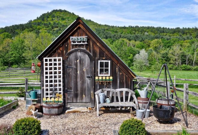 a small shed with green hills in the background
