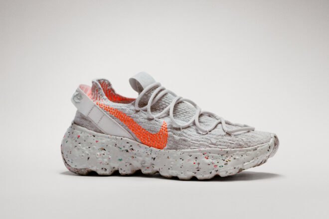 gray sneaker with orange Nike logo