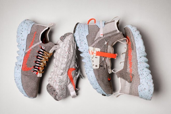 four gray sneakers with orange designs on the sides