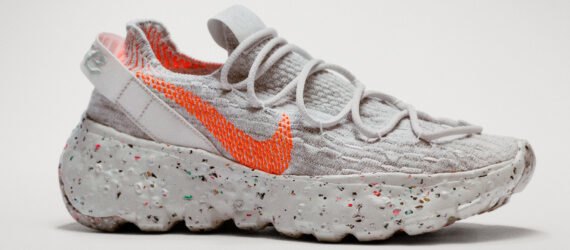 gray sneaker with orange Nike logo