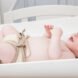 baby wearing a reusable diaper and lying on a changing table