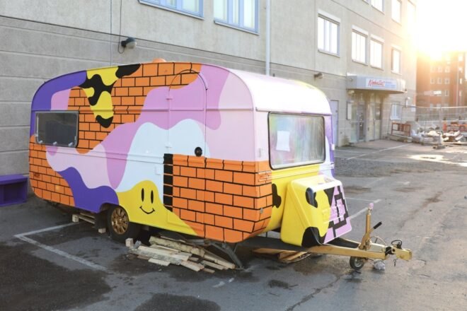 a multi-colored camper van in a parking lot
