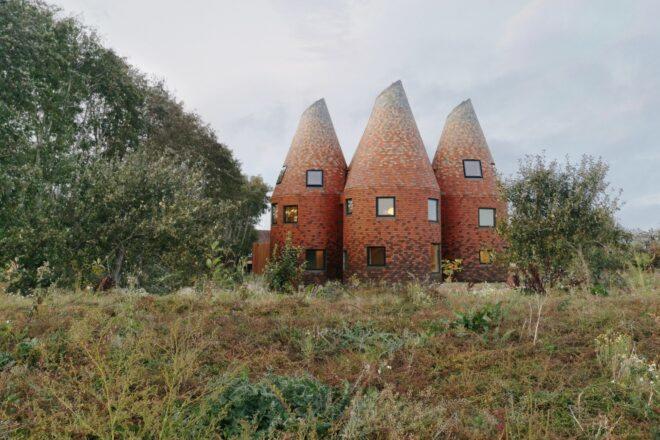 three circular towers clad in red brick