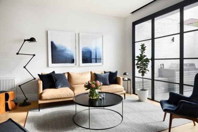 tan sofa near full-height glass doors