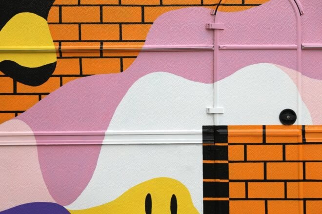 pink and white splashes of color on faux brick cladding