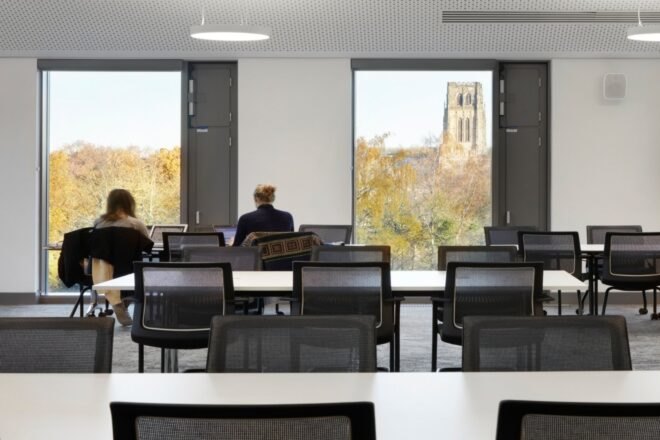 long tables with black office chairs
