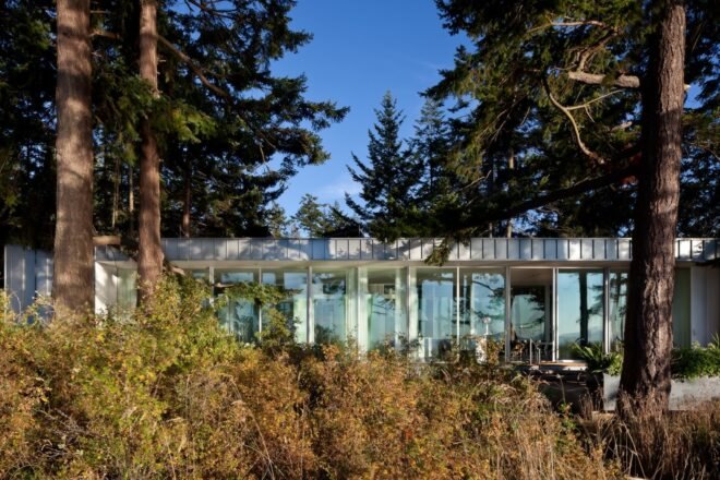 a one-story home almost hidden by greenery
